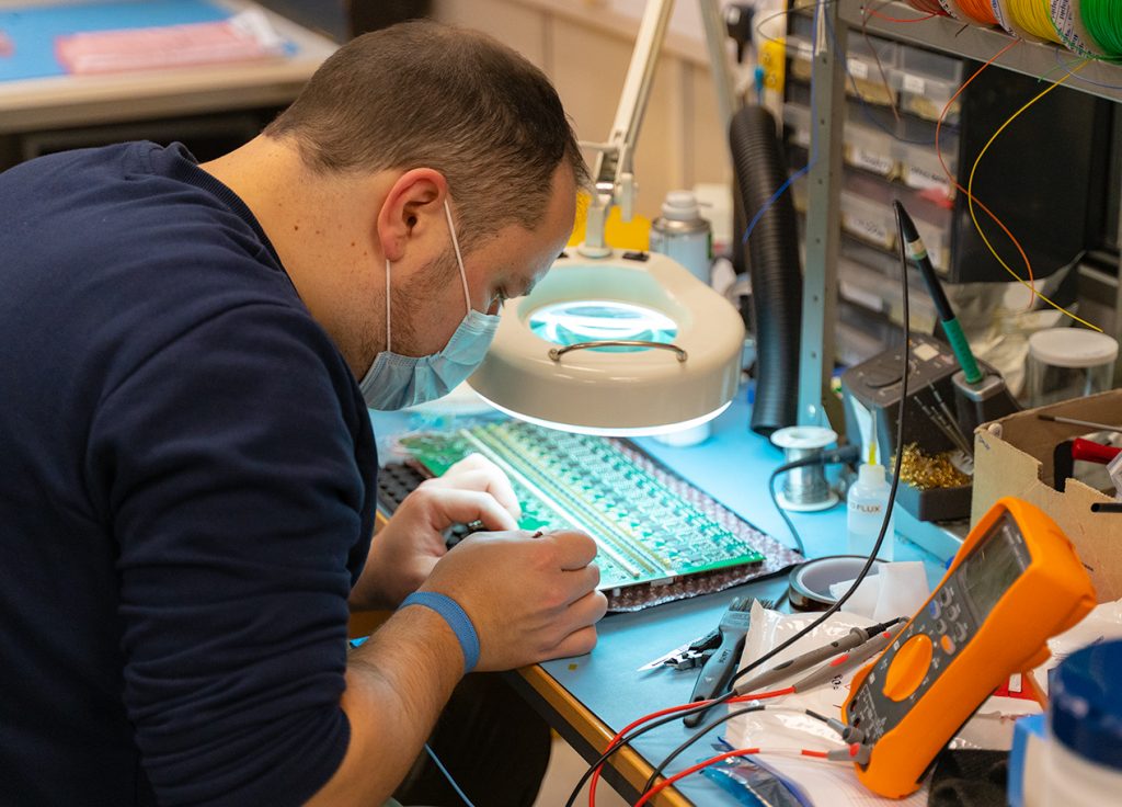 Engineer testing PCB prototype 