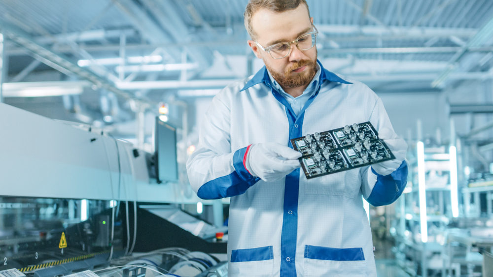 technician observing printed circuit board